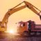 heavy wheel excavator machine working at sunset