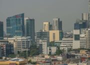 A vibrant urban skyline showcasing modern skyscrapers and diverse architecture on a clear day.
